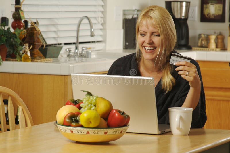 Woman using Laptop in Kitchen
