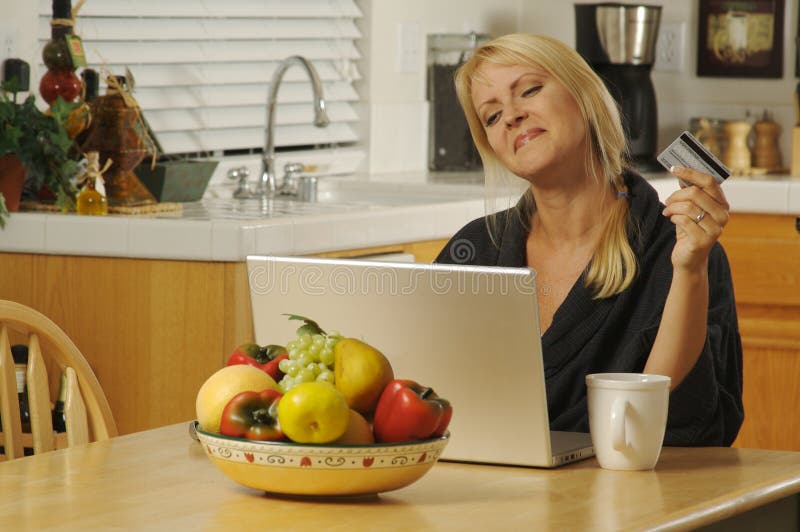 Woman using Laptop in Kitchen