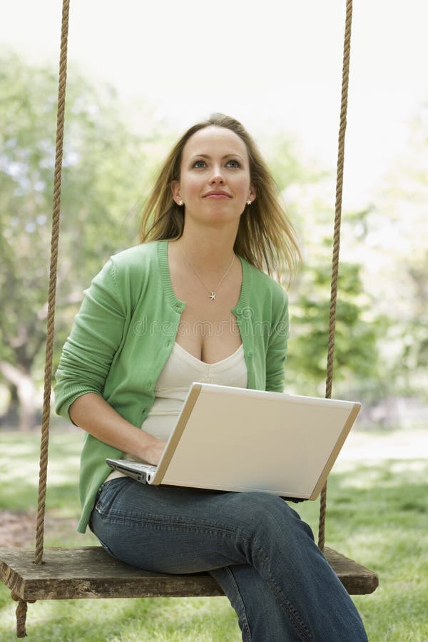 Woman Using Laptop on a Swing