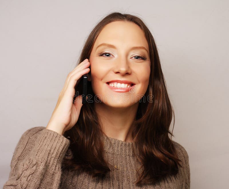 Woman Using a Mobile Phone Isolated on a White Background Stock Photo