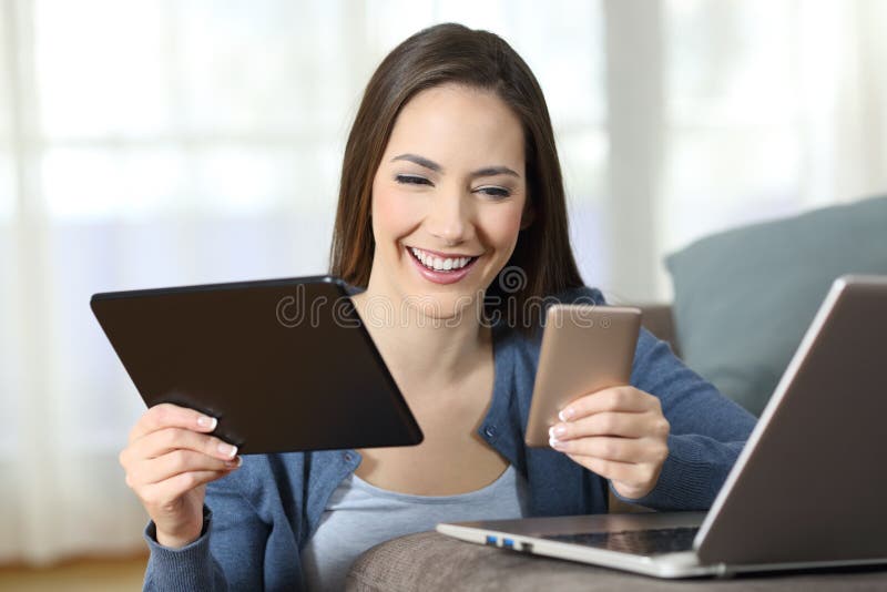 Woman Using Multiple Devices on a Couch at Home Stock Image - Image of