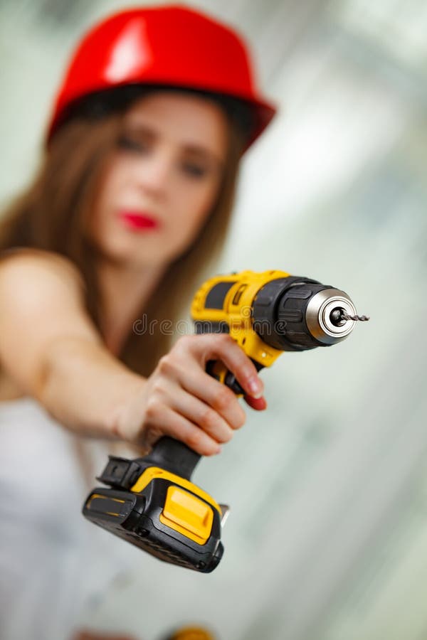 Woman using power driil for work at home royalty free stock image