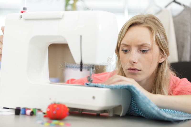 Woman using sewing machine stock photo. Image of tailoring 150198254
