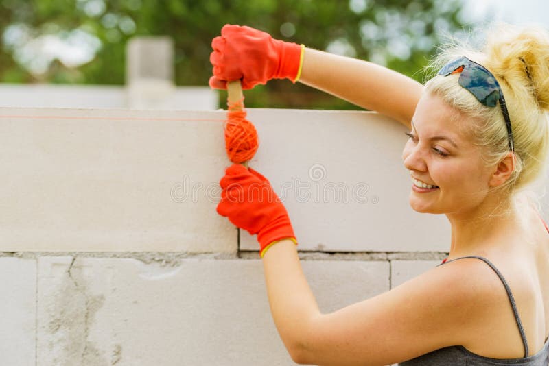 Woman using string as level in wall construction royalty free stock photo Woman using string as level in wall construction royalty free stock photo