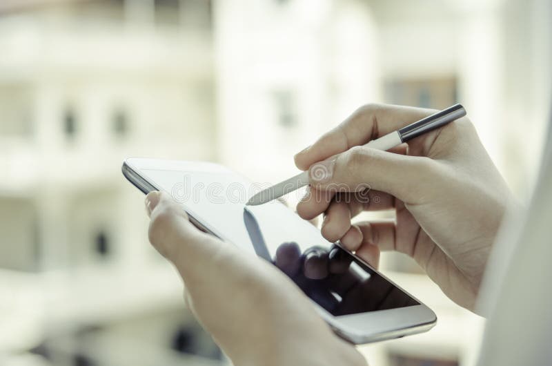 A woman using tablet with stylus pen