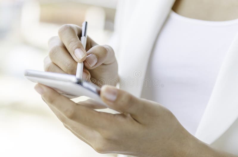 A woman using tablet with stylus pen