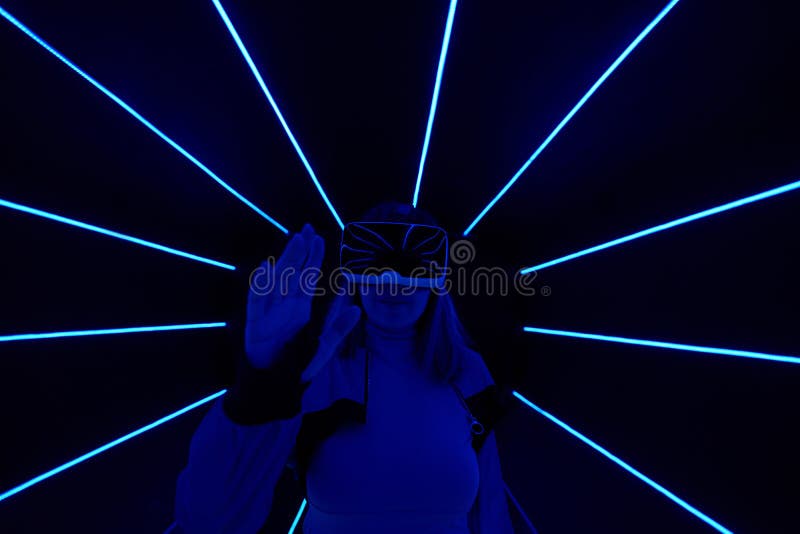Woman is using virtual reality headset to access in metaverse. Concept of virtual, augmented and extended reality, future technology, artificial intelligence and cyber security.