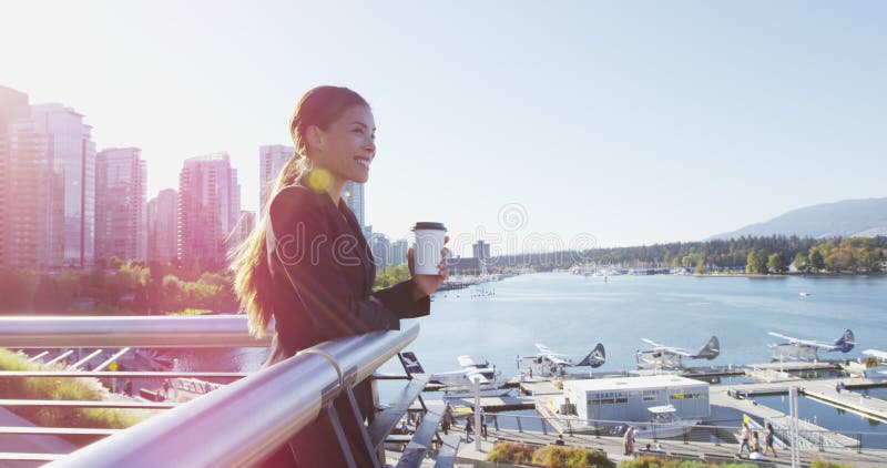 Woman in Vancouver harbour downtown looking at view happy - businesswoman break