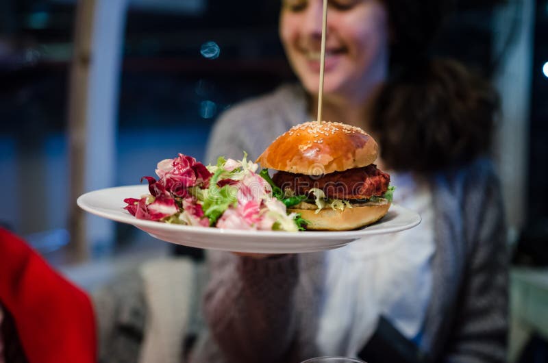 Woman with vegan food in a restaurant stock photo Woman with vegan food in a restaurant stock photo