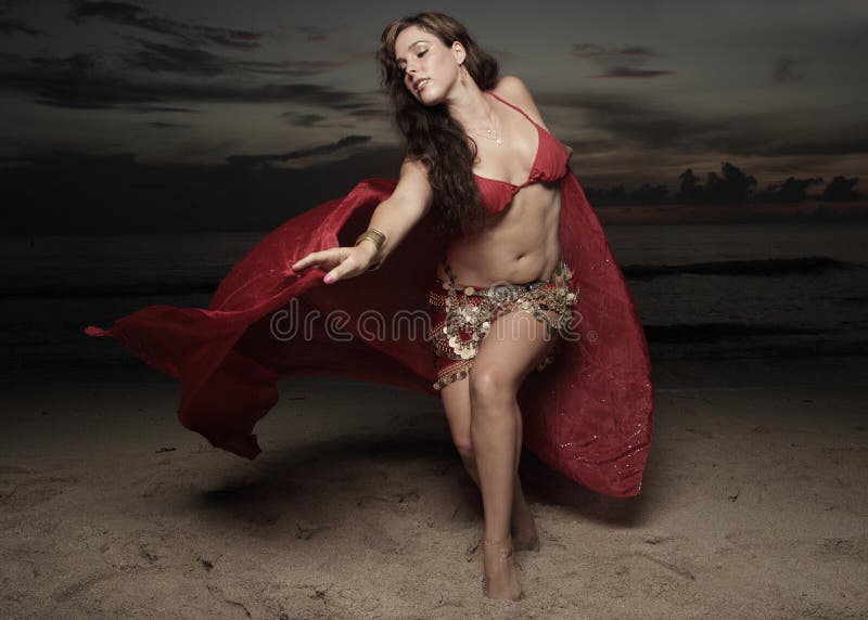 Woman with a veil on the beach