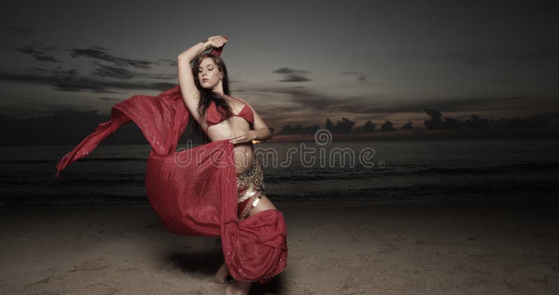 Woman with a veil on the beach