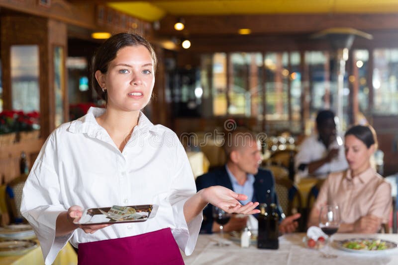 Woman waiter demonstrating her upset with small tip