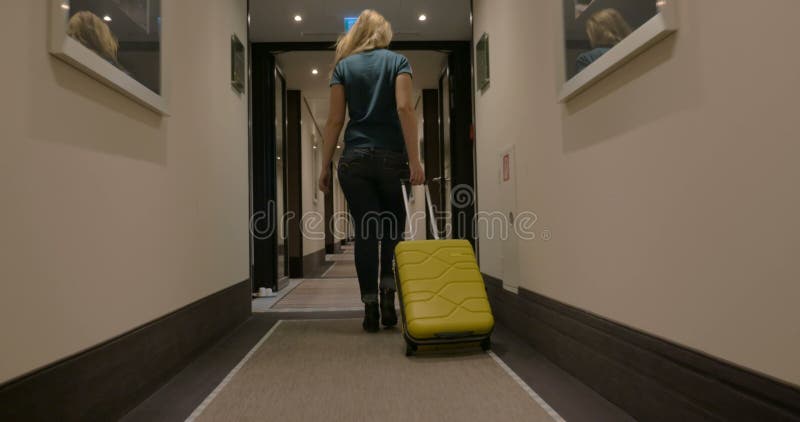 Woman Walking along the Hotel Passage with Trolley