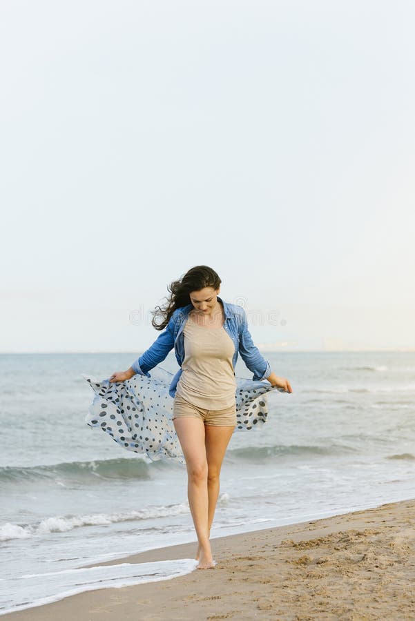 Woman walking away on the idylic beach. Enjoying, female.