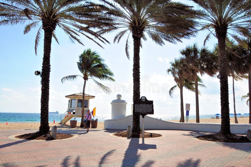 Woman walking behind lifeguard station on beach