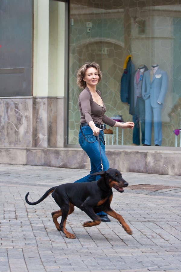 The woman walking with a dog