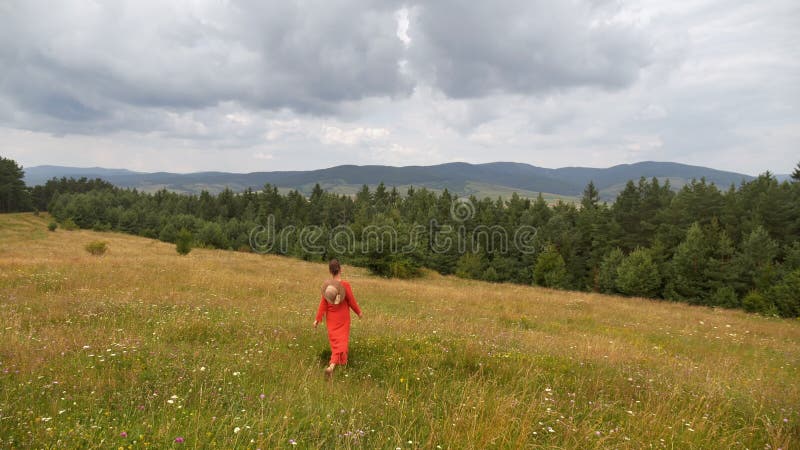 Woman walking downhill, enjoying pristine environment