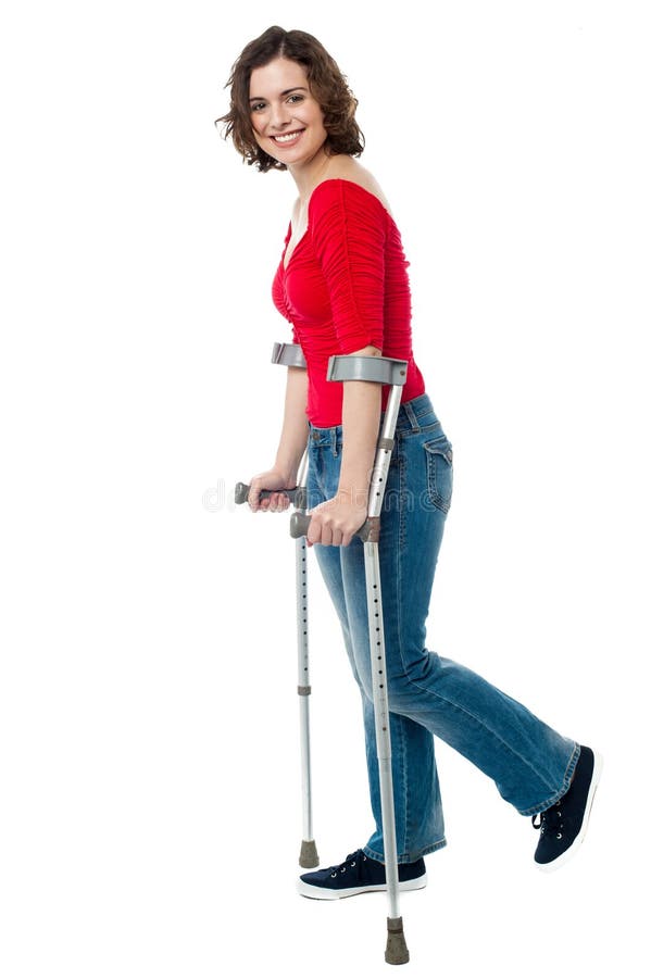 Woman walking with the help of crutches royalty free stock photo Woman walking with the help of crutches royalty free stock photo
