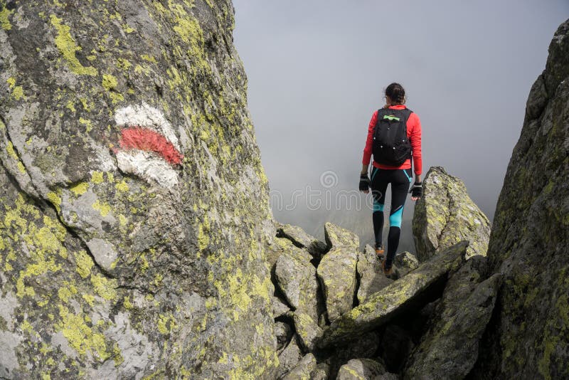 Woman walking in the mountains of Romania stock photo Woman walking in the mountains of Romania stock photo