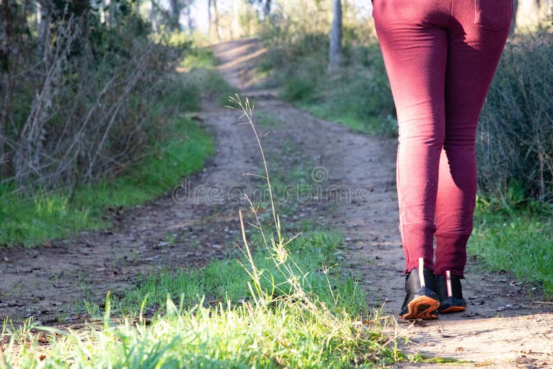 Woman walking on off-road track in the forest royalty free stock photos Woman walking on off-road track in the forest royalty free stock photos