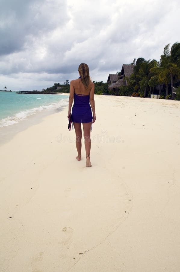 Woman walking on the sandy beach