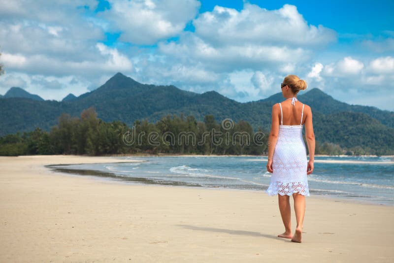 Woman walks on a beach