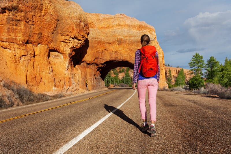 Woman walks on the road with Red canyon view