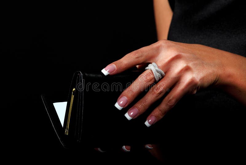 Woman with a wallet isolated on black background