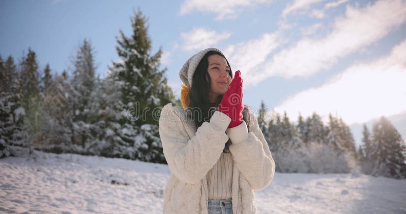 Woman Warming Hands in Snowy Mountain Landscape on a Cold Day stock video