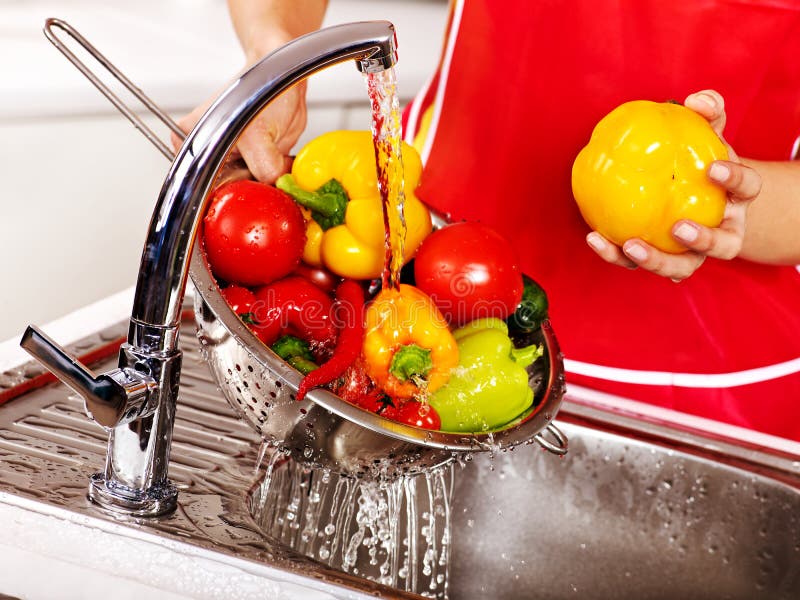 Woman Washing Fruit at Kitchen. Stock Photo Image of beautiful, happy