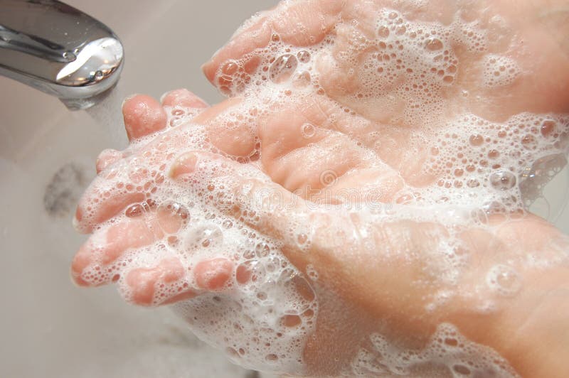 Woman washing hand under running stock images