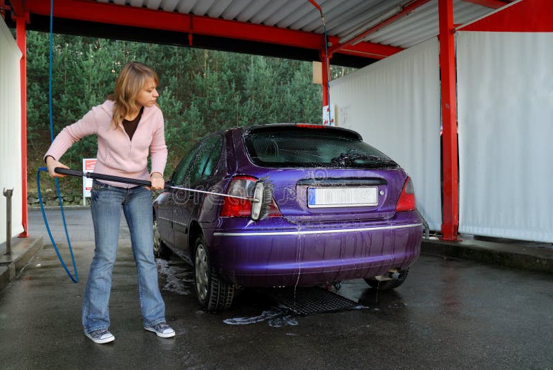 Woman washing her car stock photography