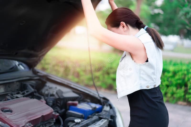 Woman watching car, engine has problems