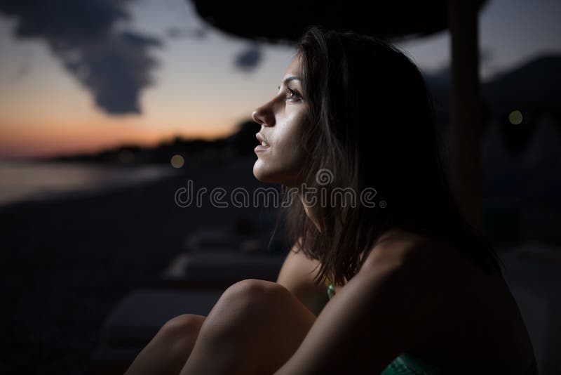 Woman watching the ocean,sea horizon with a Moon on the sky.Eclipse of the Moon.Eclipse of the sun