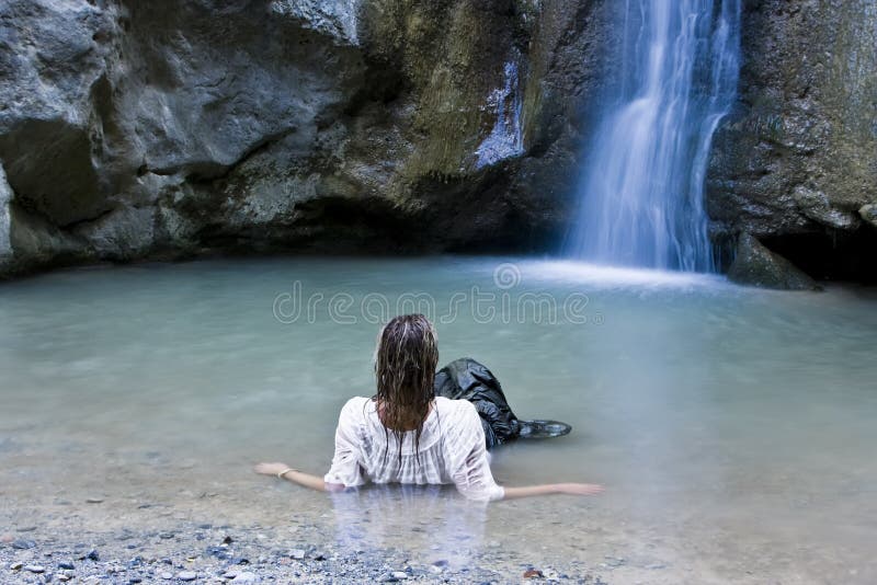 Woman in waterfall