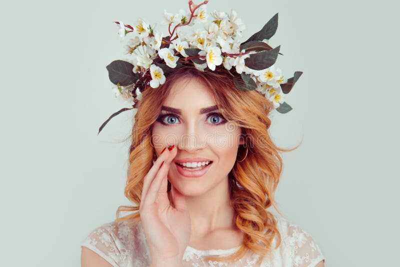 Woman wearing floral headband telling a secret royalty free stock photo Woman wearing floral headband telling a secret royalty free stock photo