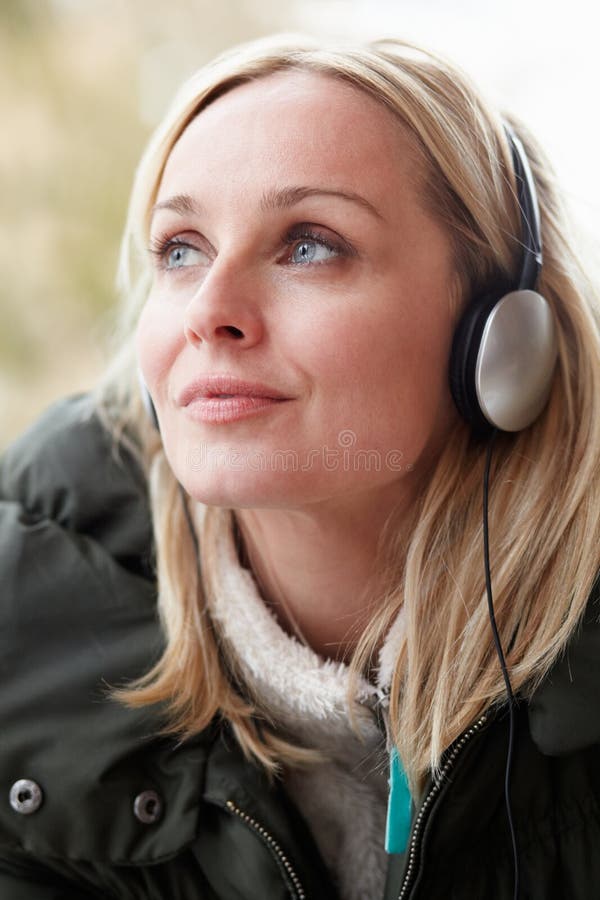 Woman Wearing Headphones And Listening To Music