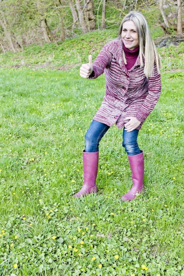 Woman wearing rubber boots stock image. Image of sweater 28527405