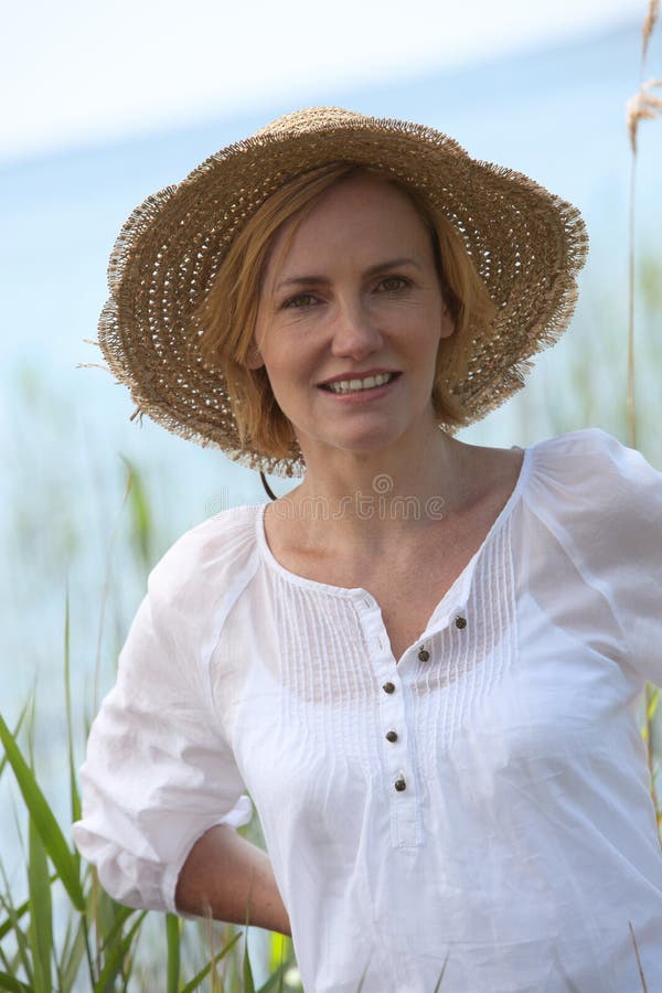 Woman wearing a straw hat stock photo. Image of supported 27386390