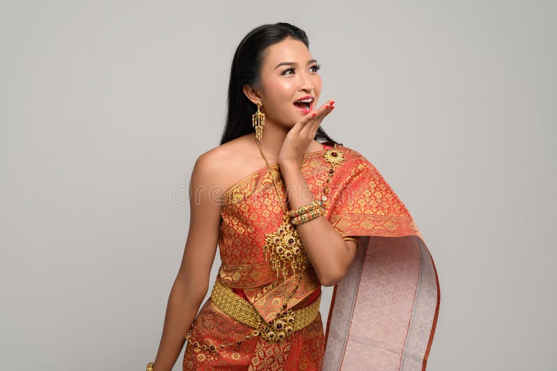 Woman wearing Thai dress that made a hand symbol