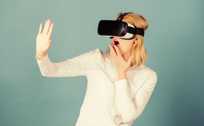 Woman wearing virtual reality goggles. Person with virtual reality helmet on blue background.Woman with virtual royalty free stock photos Woman wearing virtual reality goggles. Person with virtual reality helmet on blue background.Woman with virtual royalty free stock photos