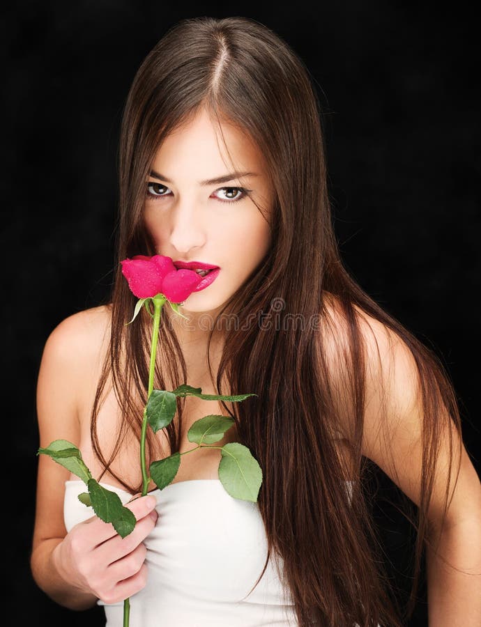 Woman with wet red rose