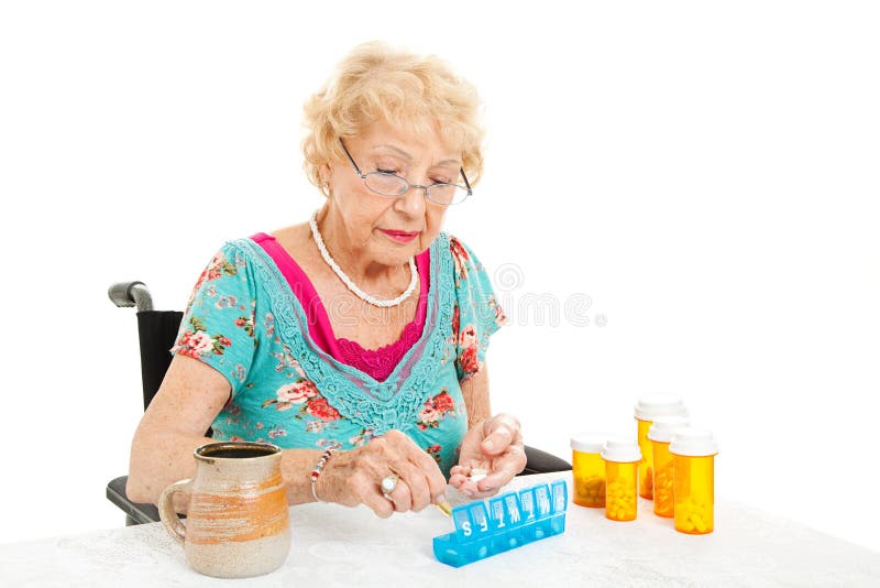 Woman In Wheelchair Counts Pills stock photo Woman In Wheelchair Counts Pills stock photo