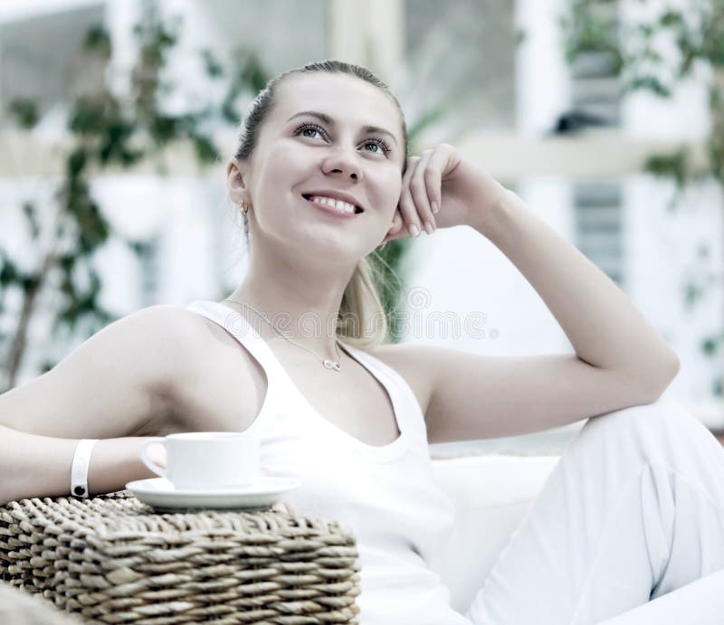 Woman in white with coffee