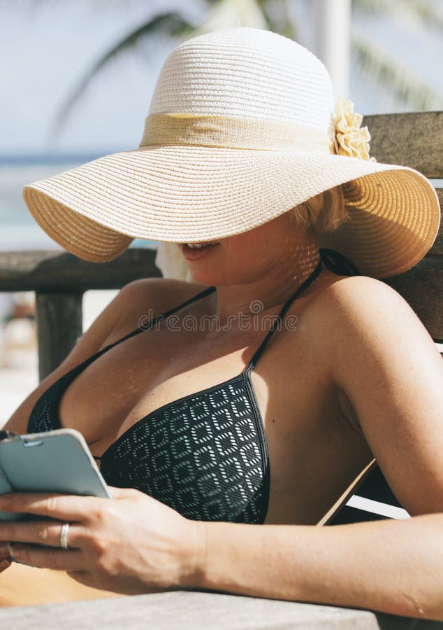 Beautiful woman with big summer hat and cigar