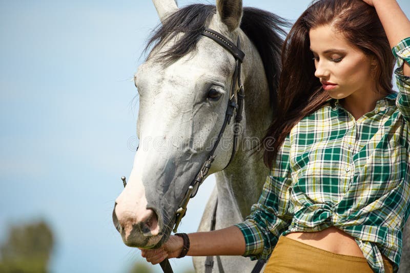 Woman with a white horse stock image Woman with a white horse stock image