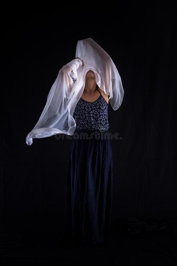 Woman with a white scarf on a black background. royalty free stock photo Woman with a white scarf on a black background. royalty free stock photo