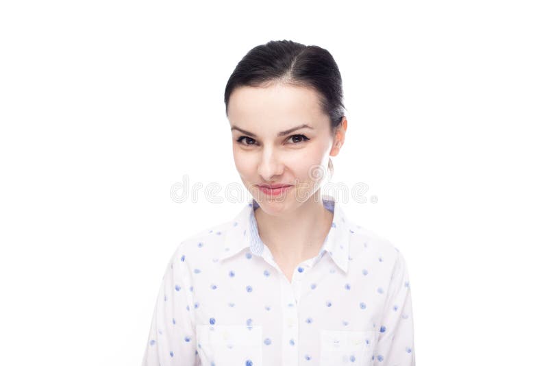 A Woman in a White Shirt with Blue Polka Dots Smiles Mysteriously