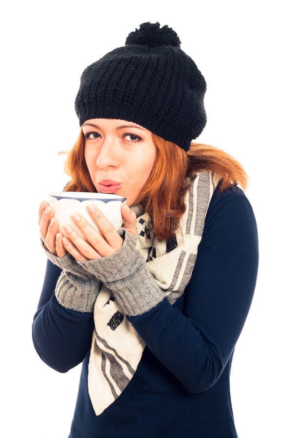 Woman in winter clothes holding mug with hot drink