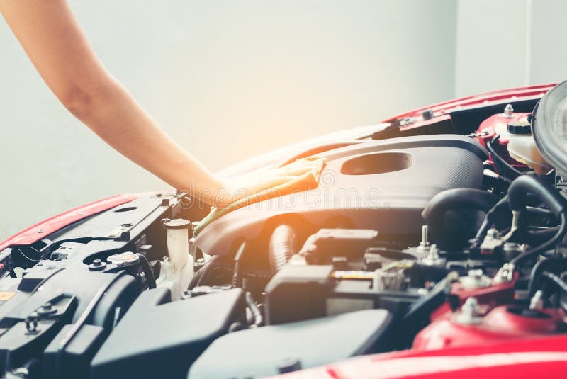 Woman wiping car engine for new vehicle, Car detailing series : stock photos Woman wiping car engine for new vehicle, Car detailing series : stock photos